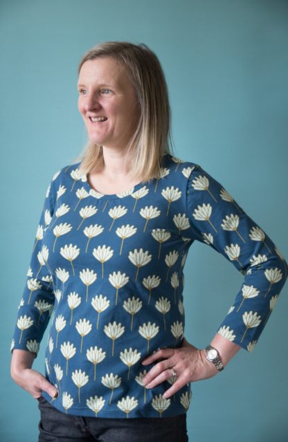 Woman wearing the Angie Top sewing pattern by Bobbins and Buttons. A T-shirt pattern made in jersey, cotton/elastane knits, viscose jersey, cotton blends or wool jersey fabrics, featuring a gentle scoop neckline and three quarter length sleeves.