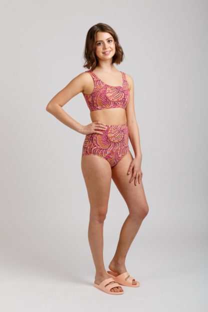 Woman wearing the Cottesloe Bikini sewing pattern from Megan Nielsen on The Fold Line. A bikini pattern made in swimsuit fabrics, featuring a scoop neckline, no fastening, underbust band and high waisted, low rise, full coverage bikini bottoms.