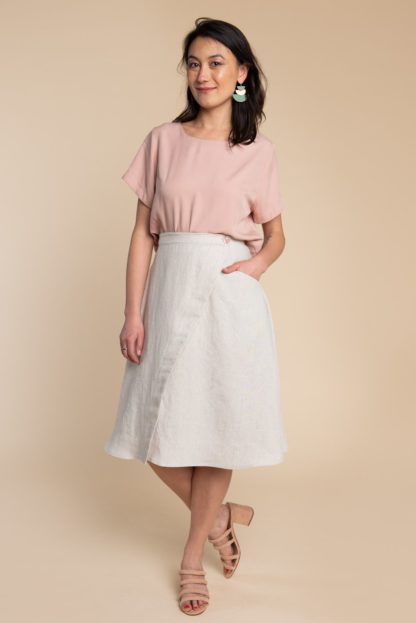 Woman wearing the Fiore Skirt sewing pattern by Closet Core Patterns. An asymmetrical wrap skirt pattern made in linen, chambray, denim or poplin fabric featuring a high waist, and single hip pocket.