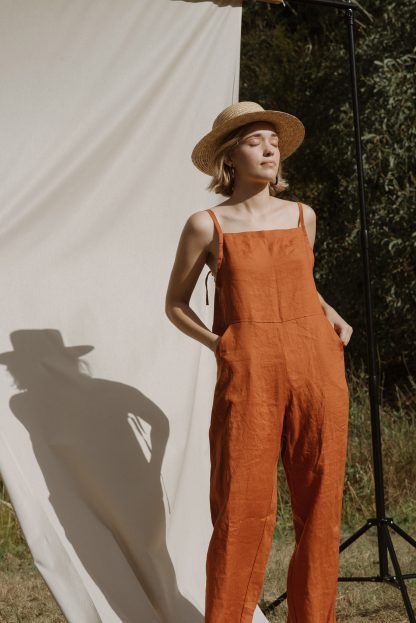 Woman wearing the Wattlebird Jumpsuit sewing pattern by Common Stitch. A jumpsuit pattern made in linen fabrics, featuring spaghetti straps, front pockets and back invisible zipper.