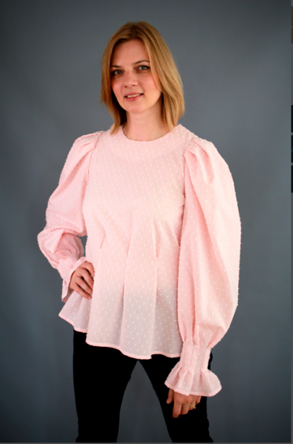 Woman wearing the Tasha Blouse sewing pattern from Lenaline Patterns on The Fold Line. A blouse pattern made in cotton poplin, satin, jersey, linen or viscose fabrics, featuring puff sleeves with gathers at the top and wrist, wrist frill, front and back waist folds, round neckline, back neck button and loop closure.