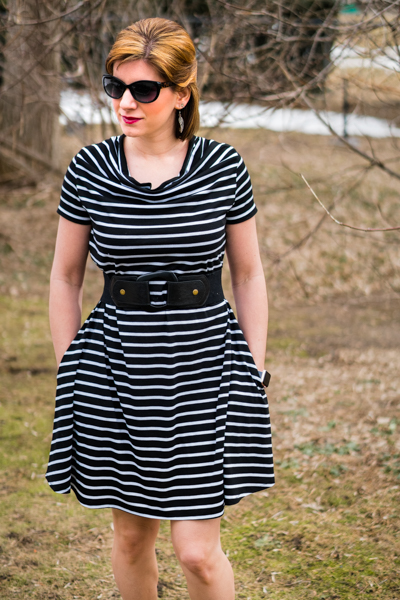 Woman wearing the Camilla Cowl Neck Dress sewing pattern by 5 out of 4 Patterns. A knit dress pattern made in knit fabrics with at least 50% stretch, featuring a cowl neck, short sleeves, in-seam pockets and above knee length.