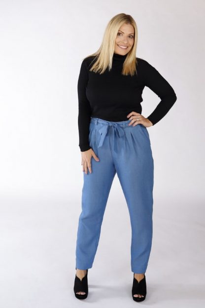 Woman wearing the Crew Trousers sewing pattern by Chalk and Notch. A pleated trouser pattern made in rayon crepe, linens or wool crepe fabrics, featuring a high waist, tapered leg, waist tie and belt loops.