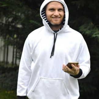 Man wearing the Halftime Hoodie sewing pattern from 5 out of 4 Patterns on The Fold Line. A hoodie pattern made in knit fabric such as medium or heavy weight cotton or poly/cotton blend sweatshirt fabric or heavy french terry, featuring full length sleeves, kangaroo pockets, hood with drawstring closure, ribbed cuffs and waistband.