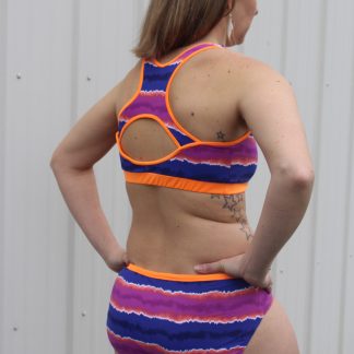 Woman wearing the X Factor Bikini Top sewing pattern from 5 out of 4 Patterns on The Fold Line. A bikini top pattern made in nylon or poly Lycra blend fabrics, featuring a racer back with centre back cut-out and scoop neckline.