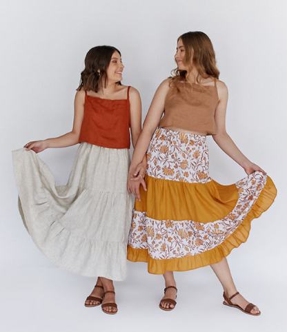 Women wearing the Fawn Skirts sewing pattern by Common Stitch. A skirt pattern made in cotton or linen fabrics, featuring a gathered tiered skirt of maxi and midi length.