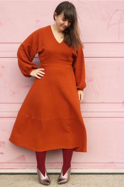 Women wearing the Belemnite Dress sewing pattern from Marilla Walker on The Fold Line. A dress pattern made in linen, cotton shirting or cotton double gauze fabrics, featuring a relaxed fit, fit and flare silhouette, long gathered sleeves, lantern shaped skirt, self-fabric ties at the waist, back zip closure and a V-neckline.