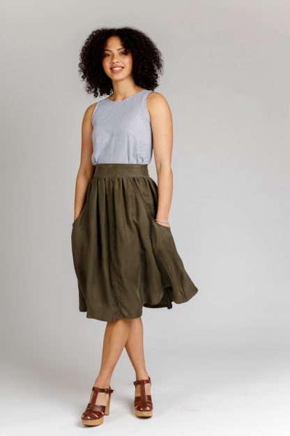 Woman wearing the Brumby Skirt sewing pattern from Megan Nielsen on The Fold Line. A skirt pattern made in denim, corduroy, linen, broadcloth, wool, cotton shirting, chambray, silk, rayon and crepe de chine fabrics, featuring deep scoop pockets, back exposed zipper, contoured waistband, knee length and gathered skirt.
