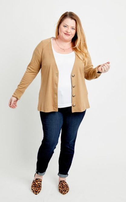 Woman wearing the Fuller Cardigan sewing pattern by Cashmerette. A cardigan pattern made in mid weight knit fabrics featuring a raglan sleeves, mid-hip length, a deep V-neck and button closure with oversized buttons.