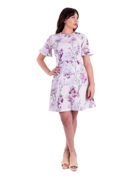 Woman wearing the Valerie Dress sewing pattern by Forget-me-not Patterns. A dress pattern made in viscose/rayons, wools, cottons or linen fabrics, featuring raglan sleeves, fitted bodice, A-line skirt, slash pockets and short sleeves finished with a flounce.