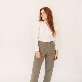 Woman wearing the Pomona Pants sewing pattern by Anna Allen. A trouser and shorts pattern made in cotton canvas, twill, medium to heavy weight linen or wool suiting fabrics, featuring an elastic waist, high rise, loose fit and patch pockets.