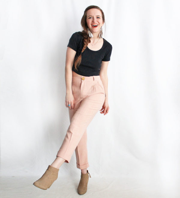 Woman wearing the Nita Trousers sewing pattern by Amy Nicole. A trouser pattern made in light to medium weight fabrics such as tencel twill, silk noil, linen and medium weight cotton fabrics, featuring a high-waist, slash front pockets, cropped length and tapered leg.