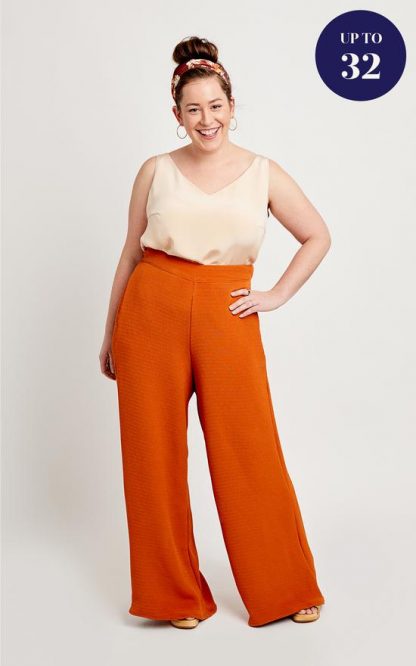 Woman wearing the Calder Trousers sewing pattern by Cashmerette. A trouser pattern made in light to mid weight wovens such as rayon, tencel, linen or chambray fabric featuring a wide leg, flat front, elasticated back waistband and in seam pockets.