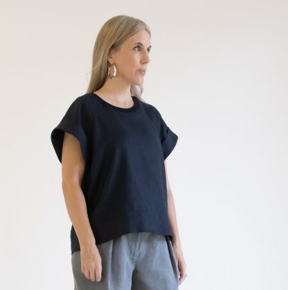 Woman wearing the Aeolian Tee sewing pattern from Pattern Fantastique on The Fold Line. A T-shirt pattern made in knit fabrics, featuring a boxy shape, square shaped short sleeve and round neck.