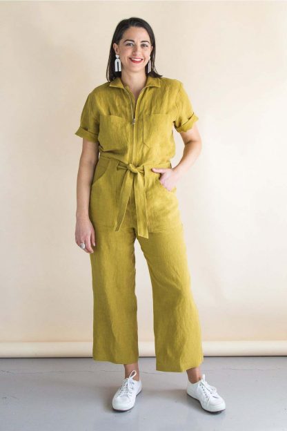 Woman wearing the Blanca Flight Suit sewing pattern by Closet Core Patterns. A semi fitted boiler suit pattern made in denim, twill, linen or cotton fabric featuring a centre front zip, patch pockets, tie belt and traditional shirt collar.