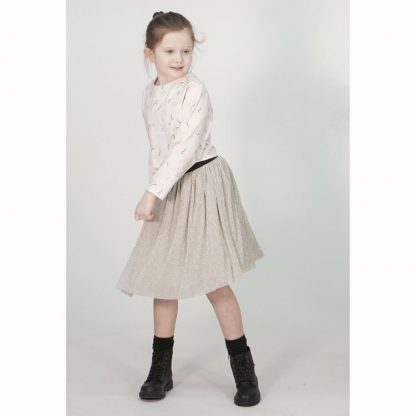 Child wearing the Child Rainee Skirt sewing pattern from Pattern Paper Scissors on The Fold Line. A skirt pattern made in tulle, netting, chiffon, georgette, crinkle, lace or voile fabrics, featuring two layers of fabric, lining, exposed elastic waistband and raw hem.