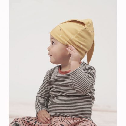 Toddler wearing the Babies' Lux Tee sewing pattern from Pattern Paper Scissors on The Fold Line. A T-shirt pattern made in jersey, sweat terry, stretch crepe, or knit fabrics, featuring a round neck with contrast neck band, and long sleeves.