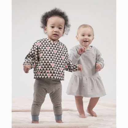 Toddlers wearing the Sparrow Sweatshirt & Dress sewing pattern from Pattern Paper Scissors on The Fold Line. A sweatshirt and dress pattern made in jersey, knit, or cotton elastane fabrics, featuring a relaxed fit, round neck, full length sleeves, dress has dropped waist.