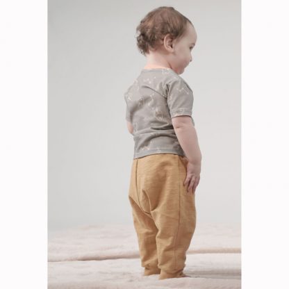 Toddler wearing the Mason Slouch Pant sewing pattern from Pattern Paper Scissors on The Fold Line. A joggers pattern made in jersey, knit, or cotton elastane fabrics, featuring a relaxed fit, full length leg with ankle cuff, gusset and deep waist band.