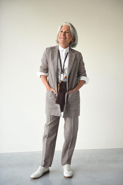 Woman wearing the Billie Trousers sewing pattern from Fibre Mood on The Fold Line. A trouser pattern made in cotton, wool or suiting fabrics, featuring side seam pockets, waistband and front zip closure, waistband sits just below natural waist, tapered leg and ankle length.