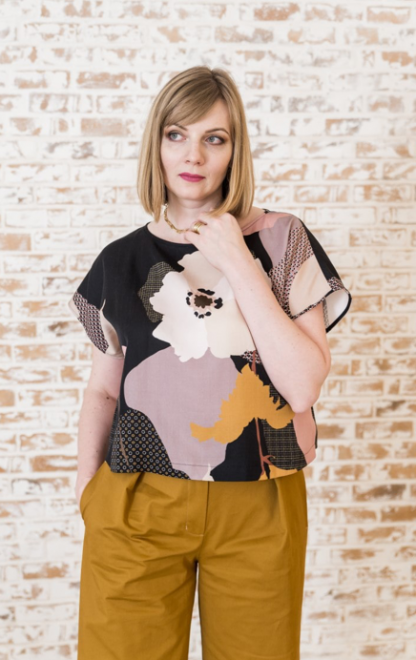 Woman wearing the Kiril Top sewing pattern from Lenaline Patterns on The Fold Line. A top pattern made in cotton, viscose, cotton plumetis, fine wool or jersey fabrics, featuring a boat neckline, boxy silhouette and short grown on sleeves.