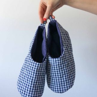 Photo showing the Unisex Quilted Slippers sewing pattern from Sew DIY on The Fold Line. A slippers pattern made in medium-weight cotton, linen, flannel, or pre-quilted fabrics, featuring an open top skimmer style and heel tab.