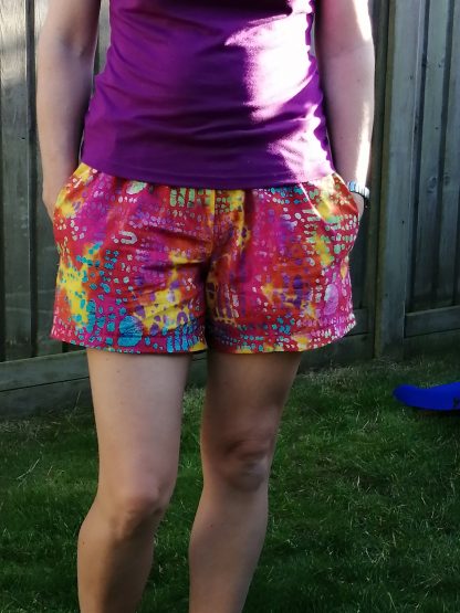 Woman wearing the Pause for Shorts sewing pattern from Waves & Wild on The Fold Line. A shorts pattern made in viscose, rayon, silk, poplin, lawn or chambray fabrics, featuring a relaxed fit, elasticated waist, low rise, pockets and waist tie.