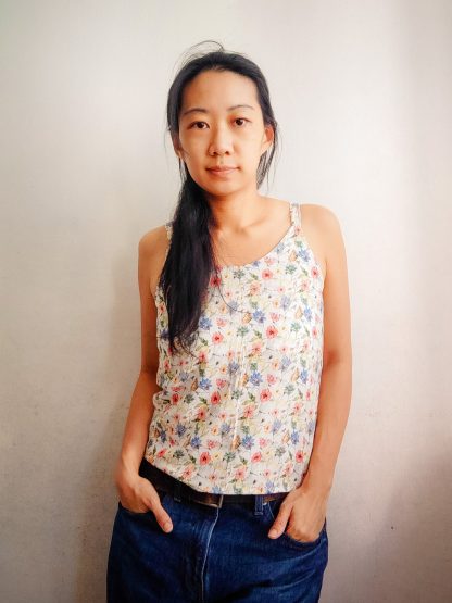 Woman wearing the Summer Breeze Camisole sewing pattern from Waves & Wild on The Fold Line. A top pattern made in viscose, rayon, silk, poplin, lawn or chambray fabrics, featuring a relaxed fit, round neck, and narrow shoulder straps.