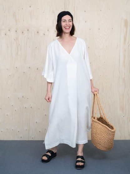 Women wearing the Kaftan Dress sewing pattern by The Assembly Line. A loose fitting dress pattern made in cotton, silk, crepe or linen featuring raglan sleeves, an overlap V-neck which creates a pleat in the front, side slits, and in-seam pockets.