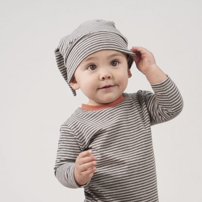Baby wearing the Birch Bunny Ear Hat sewing pattern from Pattern Paper Scissors on The Fold Line. A hat pattern made in jersey, knit or cotton elastane fabrics, featuring a stretch fit, deep band and bunny ears.