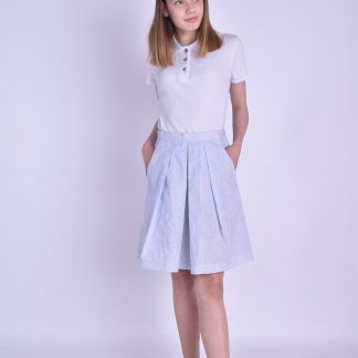 Woman wearing the Molly Skirt sewing pattern by Fieldwork Patterns. A skirt pattern made in cottons, linens or lightweight denims fabrics, featuring a concealed opening within the left pocket and flattering soft pleats into a waistband.