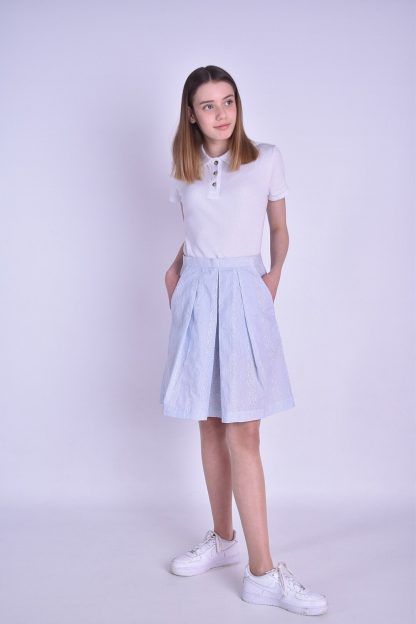 Woman wearing the Molly Skirt sewing pattern by Fieldwork Patterns. A skirt pattern made in cottons, linens or lightweight denims fabrics, featuring a concealed opening within the left pocket and flattering soft pleats into a waistband.