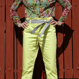 Woman wearing the Senorita Blouse sewing pattern by Alice and Co Patterns. A blouse pattern made in slinky silk jersey, bamboo, synthetic or viscose jersey or a fine wool knit fabric, featuring a front neck slit and bow tie and long sleeves that are ruched from wrist to elbow.