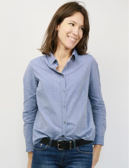 Woman wearing the Liseron Shirt sewing pattern by Atelier Scammit. A shirt pattern made in light to medium batiste, crepe, light denim or flannel fabrics, featuring a relaxed fit, front button closure and full length sleeves.