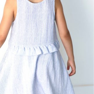 Child wearing the Baby/Child Petite Lune Dress sewing pattern by Atelier Scammit. A sleeveless dress pattern made in light to medium batiste, double gauze and light denim fabrics, featuring a full circle skirt and scooped necklines.