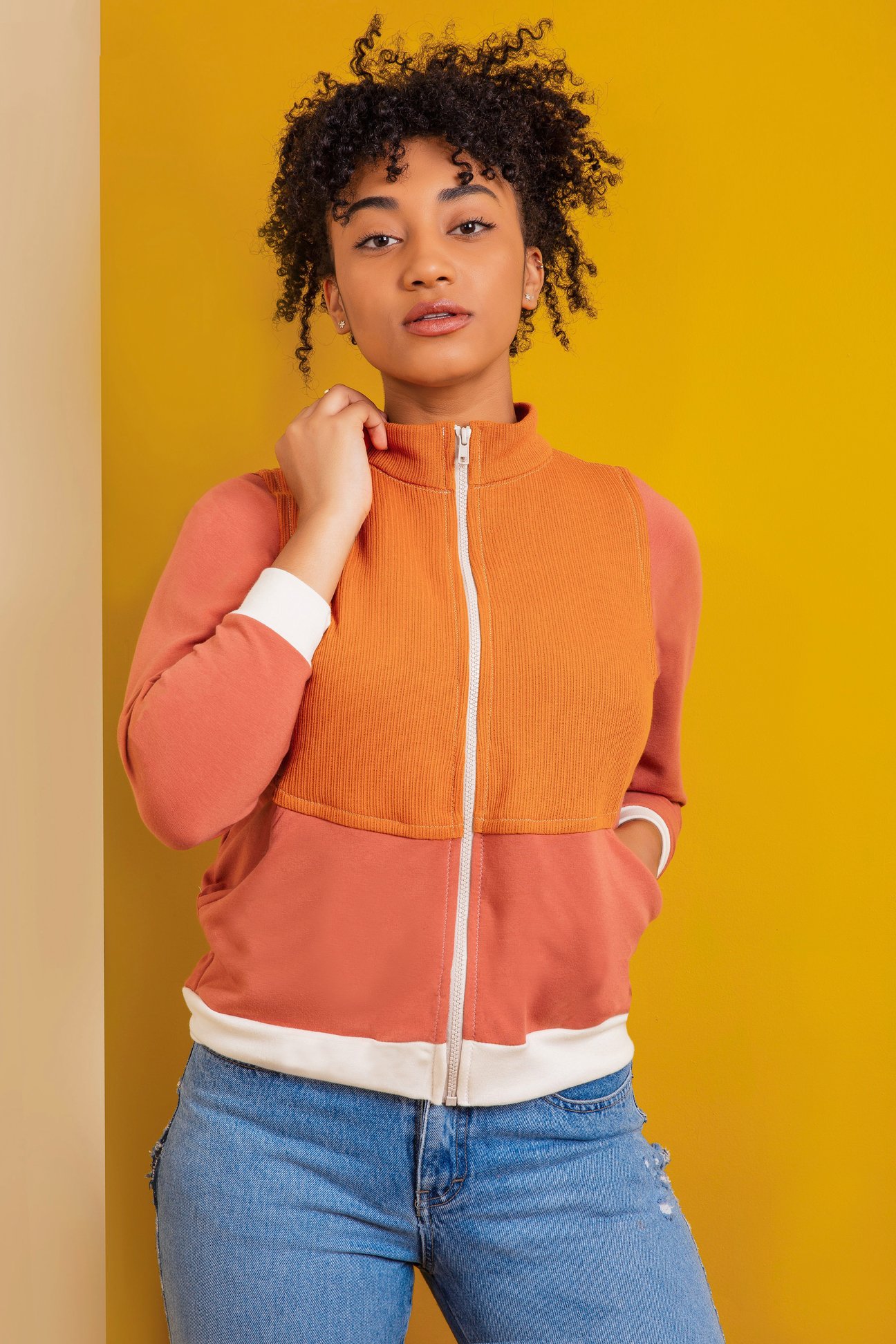 Woman wearing the Unisex Arlo Track Jacket sewing pattern by Friday Pattern Company. A lightweight jacket pattern made in knits, French terry or sweatshirt fleece featuring a sport collar, front pockets and front zip closure.