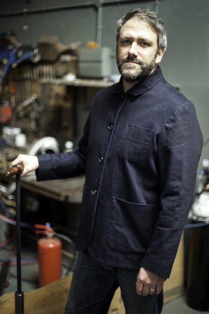 Man wearing the Foreman Jacket sewing pattern by Merchant and Mills. A jacket pattern made in twill, denim, corduroy or tweed fabric featuring a boxy style, front button closure, two piece sleeve, square collar, two hip pockets and one breast pocket.