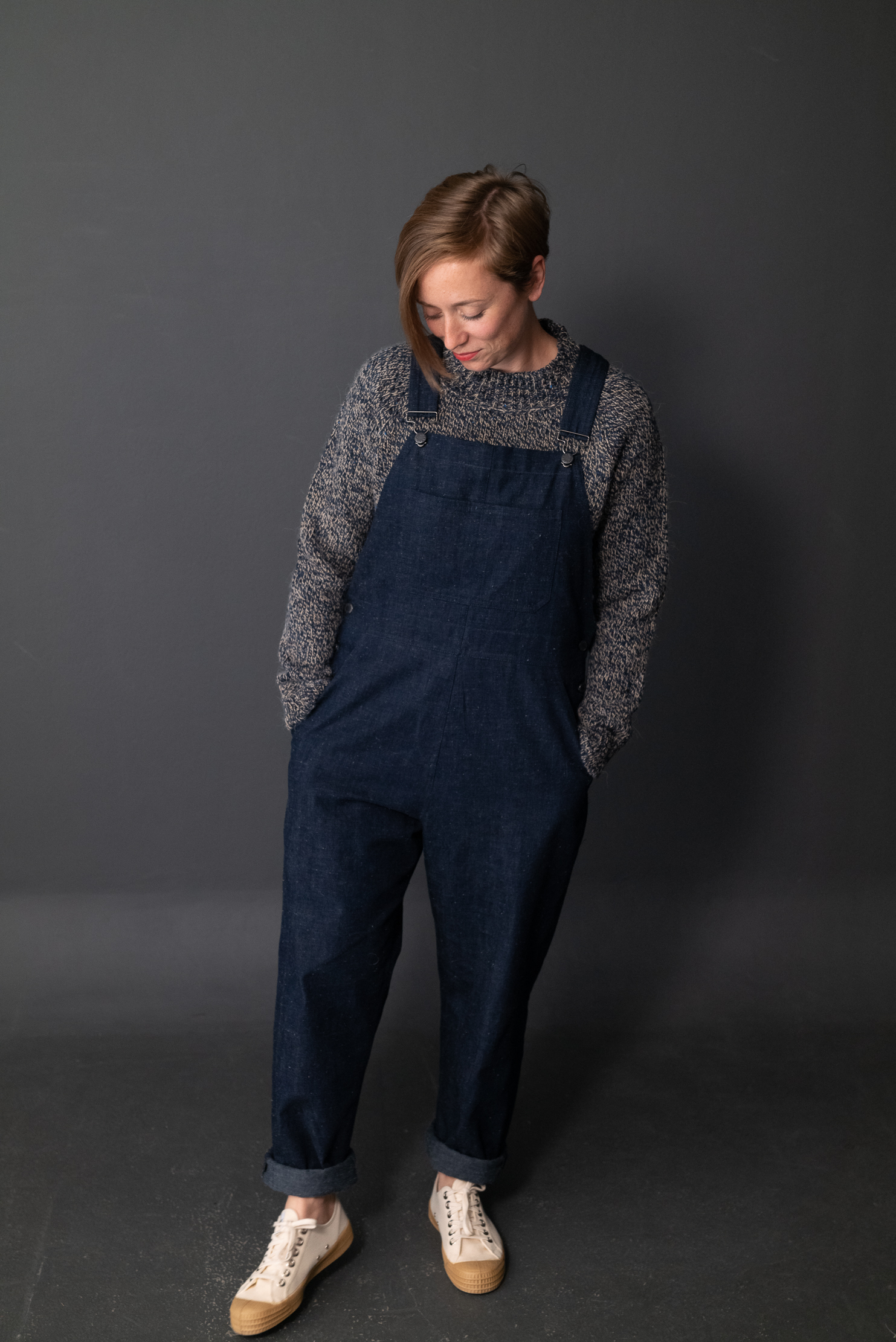 Woman wearing the Harlene Dungarees sewing pattern by Merchant and Mills. A dungaree pattern made in denim, cotton canvas, corduroy, or linen fabric featuring five pockets, top stitching and an easy fit.