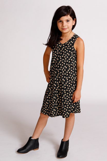 Child wearing the Baby/Child Mini Pony Dress sewing pattern by Chalk and Notch. A tank dress pattern made in light to medium weight 75% – 100% stretch knit fabrics, featuring an A-line silhouette, V-neckline and curved hem.
