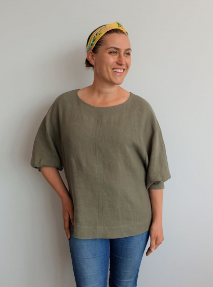 Woman wearing the Wilma Woven Top sewing pattern from Style Arc on The Fold Line. A jumper pattern made in linen, crepe or rayon fabrics, featuring a relaxed fit, round neck, hip length, slip-on style, and gusseted 7/8 length dolman sleeve with tucks.
