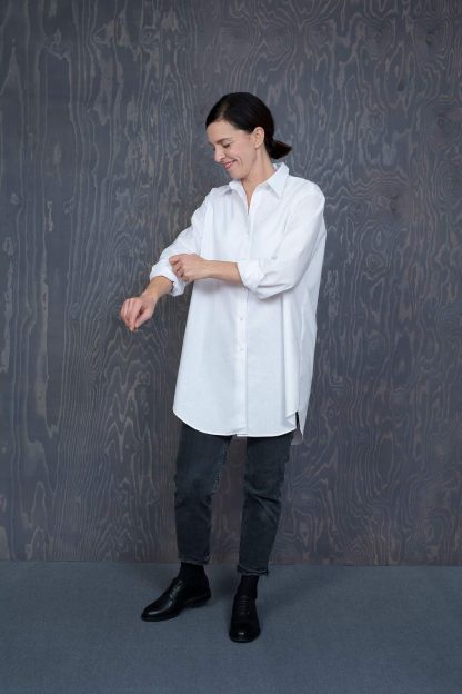 Woman wearing the Oversized Shirt sewing pattern by The assembly Line. A shirt pattern made in cotton, linen, lawn or silk fabric featuring a classic style with an oversized fit, side seam pockets, front button closure, rear box pleat and traditional shirt collar.