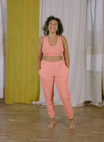 Woman wearing the Lottie Top and Bra sewing pattern from Made My Wardrobe on The Fold Line. A bra or top pattern made in medium weight knit fabrics, featuring a racerback shape that can be made full length or as a bra with an elasticated underband.