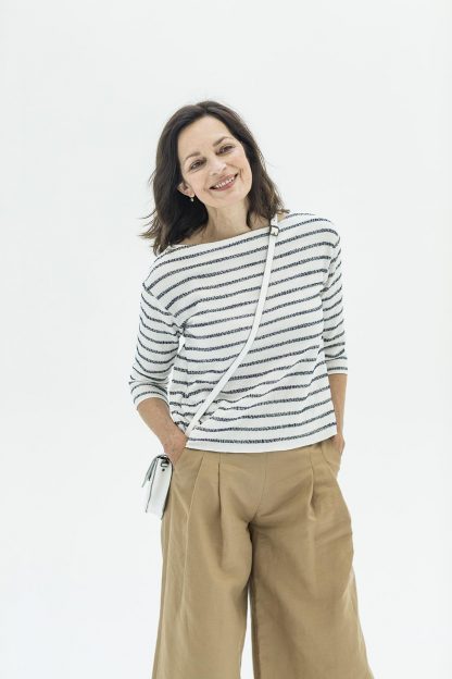 Woman wearing the Afra T-shirt sewing pattern from Fibre Mood on The Fold Line. A T-shirt pattern made in stretch knit fabrics, featuring a boat neckline, boxy fit, and ¾ length sleeves.