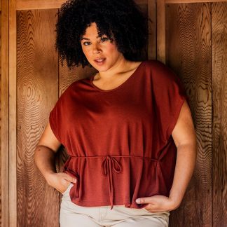 Woman wearing the Clara Top sewing pattern from Fibre Mood on The Fold Line. A knit top pattern made in Jersey fabrics, featuring a round neckline, cap sleeves and relaxed fit.