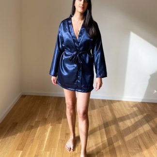 Woman wearing the Hayley Robe sewing pattern from Tammy Handmade on The Fold Line. A robe pattern made in cotton, linen, viscose, satin or silk fabrics, featuring a loose-fitting silhouette, detachable belt, belt loops, dropped shoulders, full-length sleeves and above knee length.