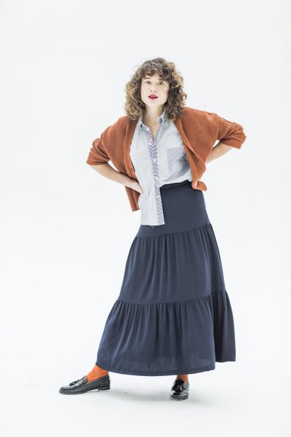 Woman wearing the Hettie Skirt sewing pattern from Fibre Mood on The Fold Line. A skirt pattern made in crepe, satin, chiffon, cotton or linen fabrics, featuring gathered tiers, maxi length, invisible back zip and waistband.