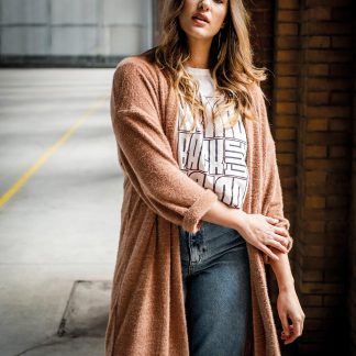Woman wearing the Luz Cardigan sewing pattern from Fibre Mood on The Fold Line. A cardigan pattern made in jacquard or knit fabrics, featuring drop shoulders, relaxed fit, knee length finish, front pockets and ¾ length sleeves.