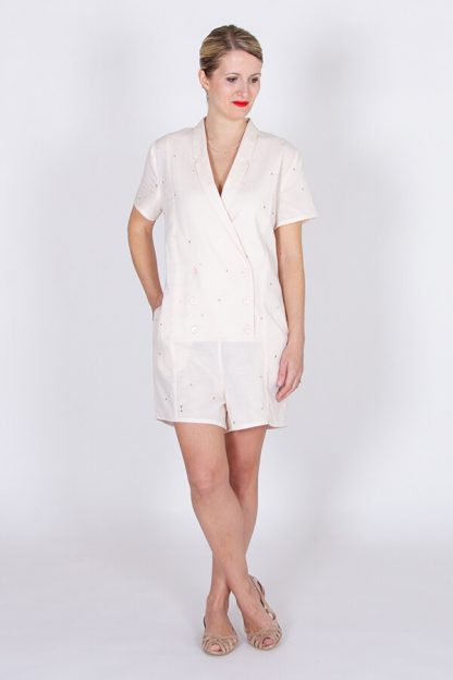 Woman wearing the Diana Playsuit sewing pattern by I AM Patterns. A playsuit pattern made in crepe, Tencel, linen, chambray, cotton, viscose twill or lightweight denim fabrics, featuring short sleeves, shawl collar, in-seam pockets and front button closure.