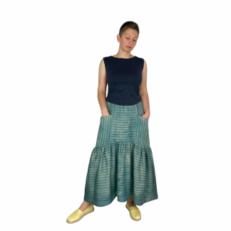 Woman wearing the Olive Skirt sewing pattern by Dhurata Davies Patterns. A tiered skirt pattern made in viscose, tencel, rayon, silk, crepe and some linen fabrics, featuring pockets, elasticated waist with minimal gathers and a dipped hem.