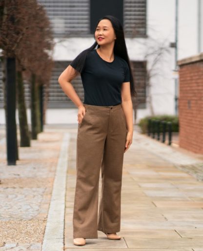 Woman wearing the Upland Trousers sewing pattern by Itch to Stitch. A trouser pattern made in linen, linen mix, twill, corduroy, suiting or poplin fabrics, featuring a high rise, no waistband, fitted through the waist and hip and relaxed at the thighs and below plus front and back pockets.